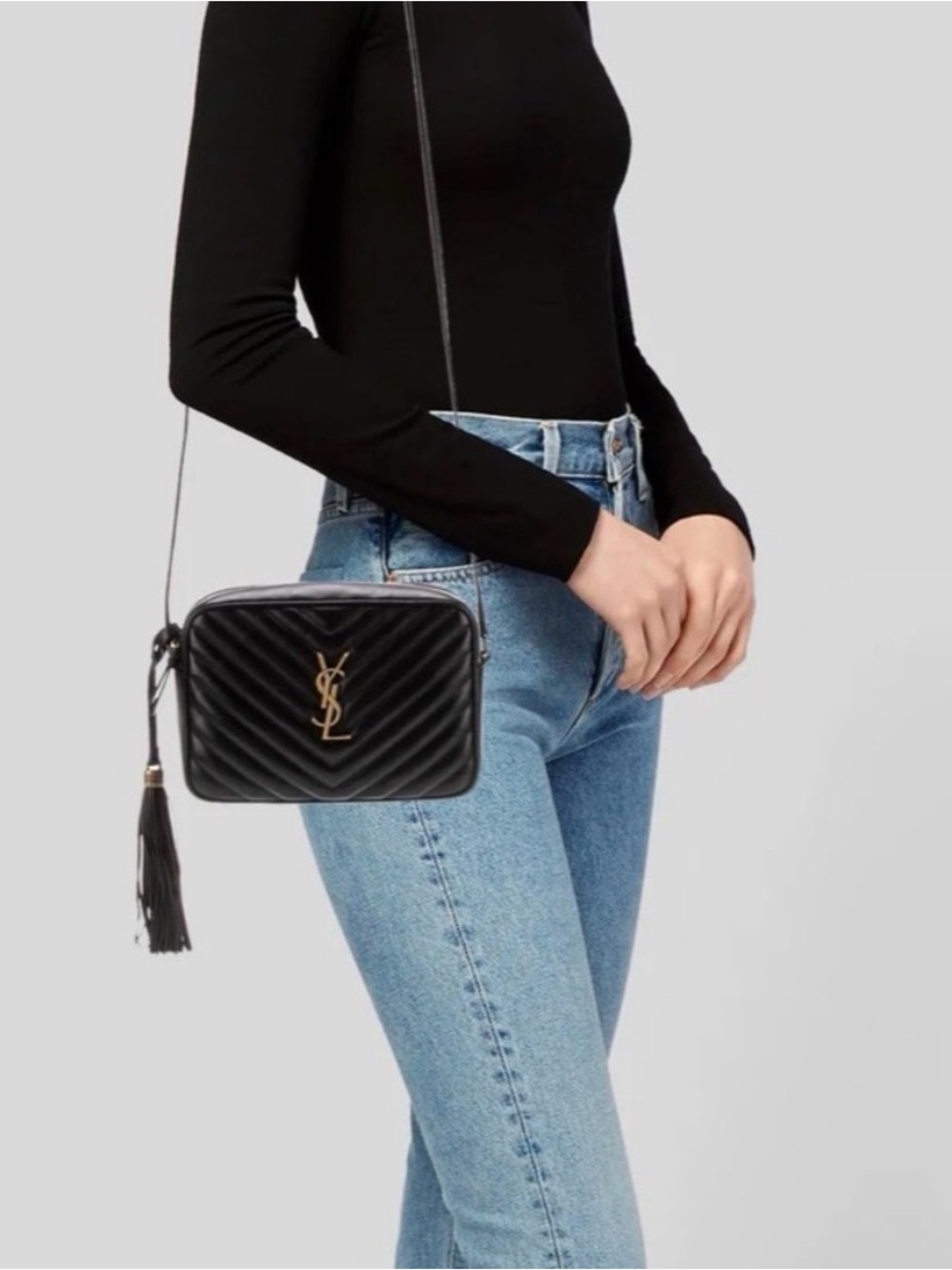 Yves Saint Laurent Black Quilted Leather Camera Crossbody Bag with tassel.